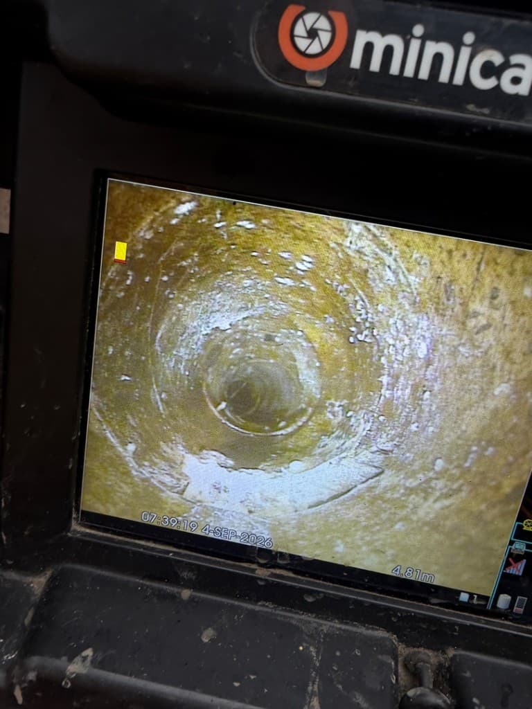 CCTV drain survey monitor showing a live camera view inside a drainage pipe